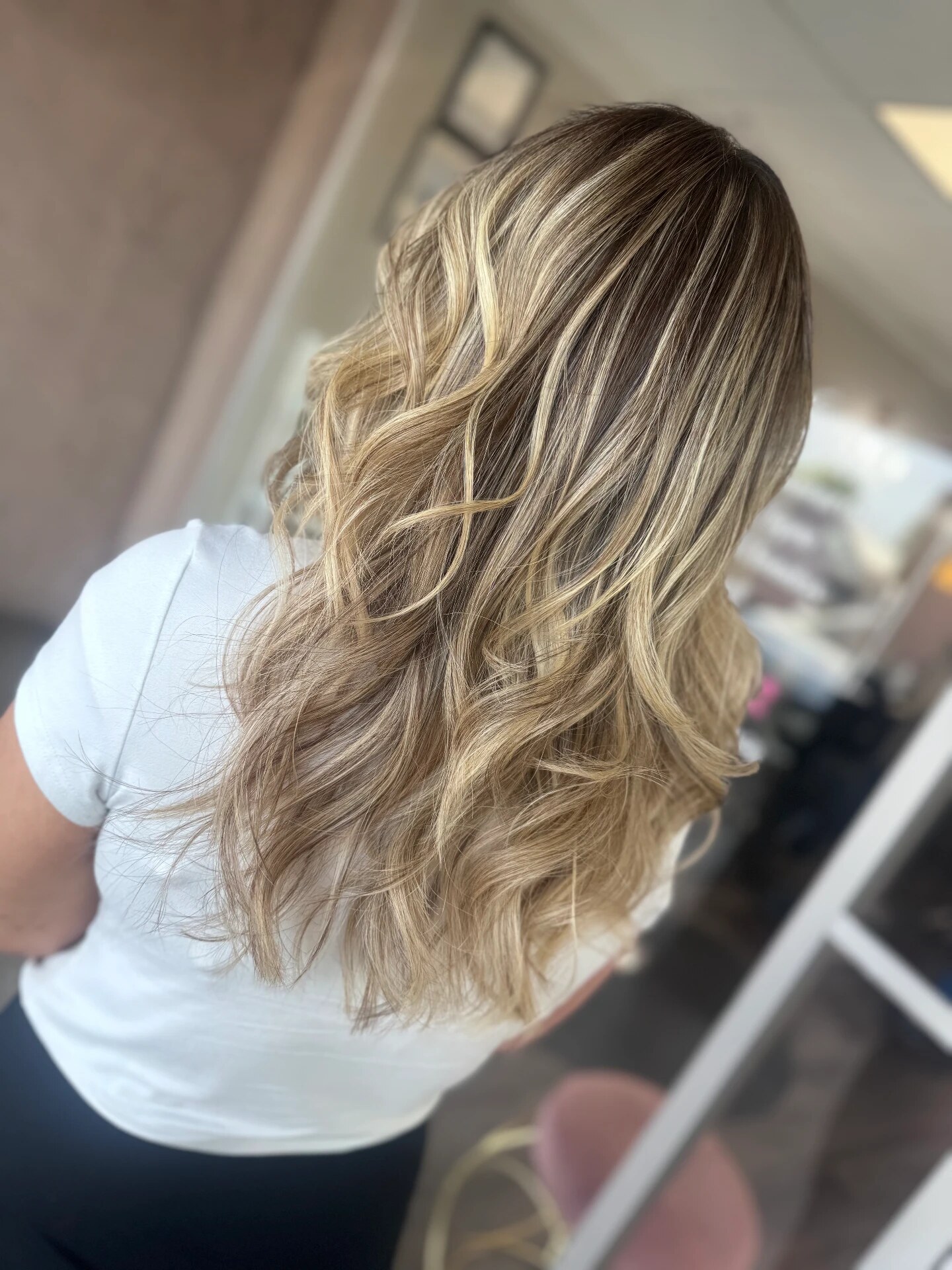 Long blonde highlighted hair styled in loose waves