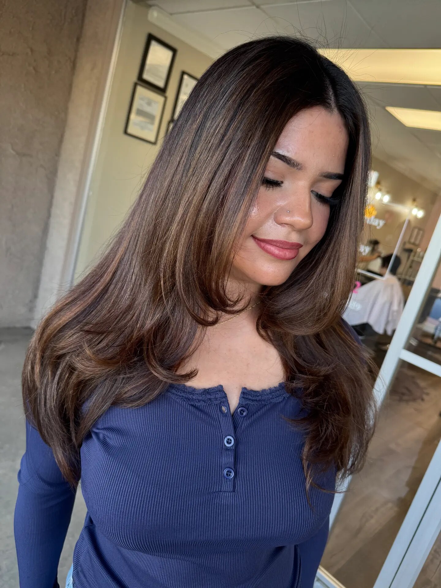 Long layered brown hair with curled ends